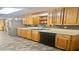 Functional kitchen with wooden cabinets, stone flooring, stainless steel appliances, and laminate countertop at 406 2Nd Sw St, Ruskin, FL 33570