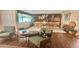 Open-concept living room with wood floors, comfortable seating, and ample space for entertaining at 406 2Nd Sw St, Ruskin, FL 33570