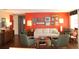 Comfortable living room with bright coral wall, modern furniture and wood floors at 406 2Nd Sw St, Ruskin, FL 33570