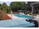 Relaxing backyard featuring a pool, a hot tub, and a covered patio with green space beyond the fence at 406 2Nd Sw St, Ruskin, FL 33570
