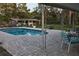 Backyard with a pool, patio, and a backdrop of lush trees, perfect for outdoor enjoyment at 406 2Nd Sw St, Ruskin, FL 33570