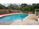 Backyard swimming pool with a brick pool deck and a safety ladder at 406 2Nd Sw St, Ruskin, FL 33570