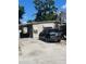 Single story home with carport, compact yard, and neutral color scheme in a suburban setting at 6591 50Th N St, Pinellas Park, FL 33781