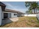 Backyard showing a partial view of the home and surrounding privacy fence at 4435 Sail Dr, New Port Richey, FL 34652