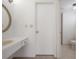 Bright bathroom features a vanity with a sink, mirror, and toilet at 4435 Sail Dr, New Port Richey, FL 34652