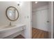Bathroom featuring a vanity with a sink, mirror, and adjacent closet at 4435 Sail Dr, New Port Richey, FL 34652