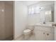 This is a bathroom with a tile shower, toilet, vanity with a sink, and a window at 4435 Sail Dr, New Port Richey, FL 34652
