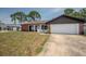 Inviting single-Gathering home featuring an attached garage and a cozy front yard at 4435 Sail Dr, New Port Richey, FL 34652
