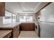 Well lit Kitchen featuring wood cabinets and views of the backyard through the window at 4435 Sail Dr, New Port Richey, FL 34652