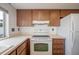A Kitchen featuring wood cabinets, a window, and appliances at 4435 Sail Dr, New Port Richey, FL 34652