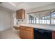 Bright kitchen with white counters, wooden cabinets, tile floors, and a dishwasher at 4435 Sail Dr, New Port Richey, FL 34652