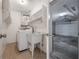 Laundry room and garage with modern appliances, utility sink and storage shelves at 4435 Sail Dr, New Port Richey, FL 34652