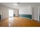 Large living room with parquet floors, green chair rail, and access to the patio at 4435 Sail Dr, New Port Richey, FL 34652
