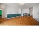 A bright living room with parquet floors, green chair rail, and a fireplace at 4435 Sail Dr, New Port Richey, FL 34652