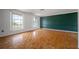 Living room showcasing hardwood floors, large windows, and neutral decor at 4435 Sail Dr, New Port Richey, FL 34652