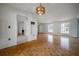 Open-concept living room showcasing hardwood floors, white walls, and ample lighting at 4435 Sail Dr, New Port Richey, FL 34652