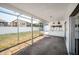 Enclosed patio that provides a view of the private backyard and fence at 4435 Sail Dr, New Port Richey, FL 34652