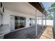 Covered patio with a pass-through bar area, concrete floor, and a screened enclosure at 4435 Sail Dr, New Port Richey, FL 34652