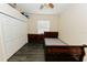 Simple bedroom with wood-look floors, closet, and a single bed frame at 4657 Parkway Blvd, Land O Lakes, FL 34639