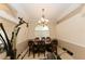 Formal dining room with elegant chandelier, arched window, and carved wood chairs at 4657 Parkway Blvd, Land O Lakes, FL 34639
