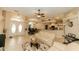 Open-concept living room features tile floors, ceiling fan, breakfast bar, and lots of natural light at 4657 Parkway Blvd, Land O Lakes, FL 34639