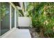 Patio area with lush tropical landscaping, offering a private outdoor retreat at 5024 Sylvester Loop, Tampa, FL 33610