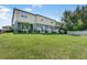 Exterior of a townhome community with a sprawling green lawn and well-maintained landscaping at 5024 Sylvester Loop, Tampa, FL 33610