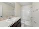 Bright bathroom with white tiled shower and tub combo, complemented by a dark wood vanity at 5024 Sylvester Loop, Tampa, FL 33610