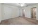 Carpeted bedroom with ceiling fan, closet, and attached bathroom at 5024 Sylvester Loop, Tampa, FL 33610