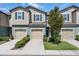 Charming townhome with individual garages, manicured landscaping, and neutral color palette at 5024 Sylvester Loop, Tampa, FL 33610