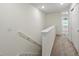 Upstairs hallway with carpeting, leading to bedrooms and storage closet at 5024 Sylvester Loop, Tampa, FL 33610
