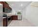 Well-lit kitchen with stainless steel appliances, tile floors and white walls at 5024 Sylvester Loop, Tampa, FL 33610