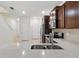 Kitchen counter view with stainless steel sink and appliances, white walls and tile floors at 5024 Sylvester Loop, Tampa, FL 33610
