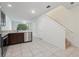 Open concept kitchen area with stainless steel appliances, white walls and tile floors at 5024 Sylvester Loop, Tampa, FL 33610
