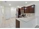 Kitchen features stainless steel appliances, dark wood cabinets, and tile floors at 5024 Sylvester Loop, Tampa, FL 33610