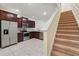 Well-lit kitchen boasts stainless steel appliances, dark wood cabinets, and tile flooring at 5024 Sylvester Loop, Tampa, FL 33610