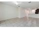 Bright living room features tiled floors, ceiling fan, and seamless transition to kitchen at 5024 Sylvester Loop, Tampa, FL 33610
