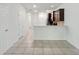 Open-concept living room features tile floors and seamless transition to kitchen with modern cabinetry at 5024 Sylvester Loop, Tampa, FL 33610