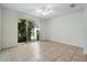Light-filled room with ceiling fan and sliding glass door leading to outdoor patio at 5024 Sylvester Loop, Tampa, FL 33610