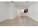 Open living space with tile flooring leading to a modern kitchen with dark wood cabinets at 5024 Sylvester Loop, Tampa, FL 33610