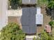 Aerial view of the house with a dark roof and green trees nearby at 5027 Overton Dr, New Port Richey, FL 34652