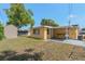 View of a yellow house with a shed and carport at 5027 Overton Dr, New Port Richey, FL 34652