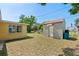 Spacious backyard with a storage shed, green grass, and some trees perfect for outdoor activities at 5027 Overton Dr, New Port Richey, FL 34652