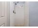 Shower with new shower head and white tile at 5027 Overton Dr, New Port Richey, FL 34652