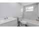 Bright bathroom features marble tile surround, modern fixtures and a new toilet at 5027 Overton Dr, New Port Richey, FL 34652