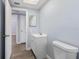 Updated bathroom featuring a modern vanity, toilet, and tile flooring, complemented by neutral paint at 5027 Overton Dr, New Port Richey, FL 34652