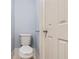 This bathroom features a white toilet, tile flooring, and light blue painted walls at 5027 Overton Dr, New Port Richey, FL 34652