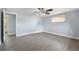 Spacious bedroom with ceiling fan and grey wood floors at 5027 Overton Dr, New Port Richey, FL 34652