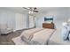 Staged bedroom with closet, modern ceiling fan and grey wood floors at 5027 Overton Dr, New Port Richey, FL 34652