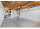 A large garage space with painted walls and concrete floors as well as washer and dryer at 5027 Overton Dr, New Port Richey, FL 34652